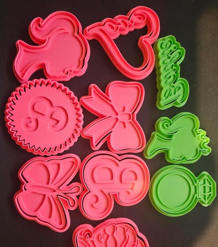 set of 10 barbie cookie cutters and stamps.