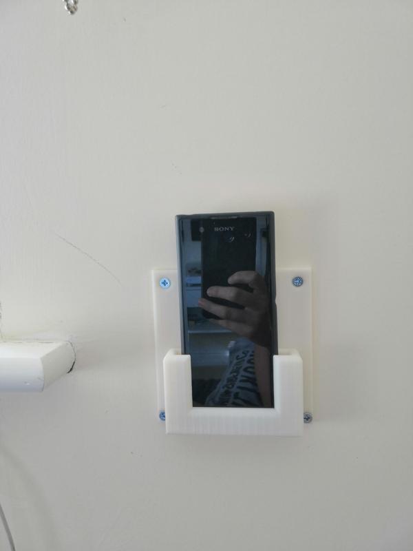 Wall mounted phone holder