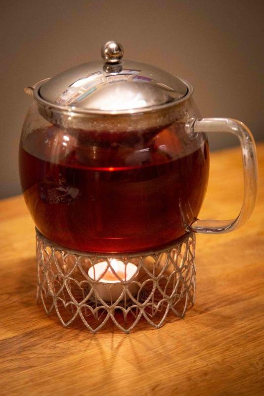 Tea pot holder with heating candle