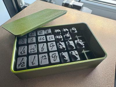 Alphabet of curly font for working with clay with a case