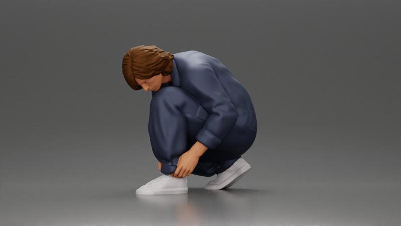 Worker injumpsuit Squatting Down, Carefully Adjusting His Pants with Focus