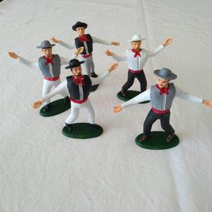 Four santons of farandole dancers