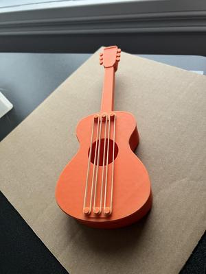 Rubber band powered guitar with pick