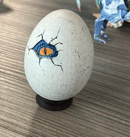 Hatching dino egg with raptor eye