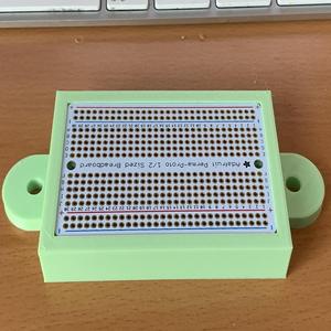 Mount for a half size Perma Proto Board on an 8020 Series 10 extrusion