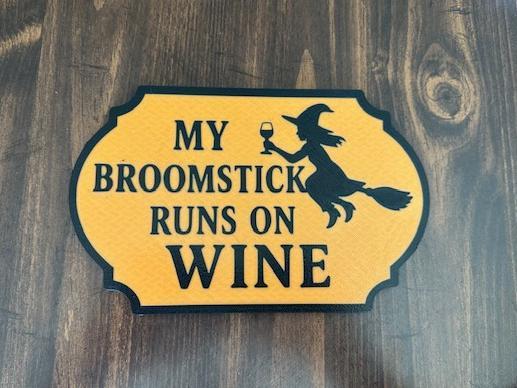 Broomstick runs on wine sign