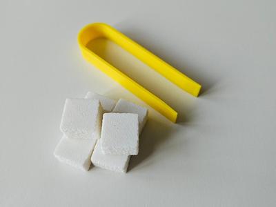 Sugar cubes with tongs