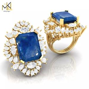 RING with deep blue color stone embraced by diamonds