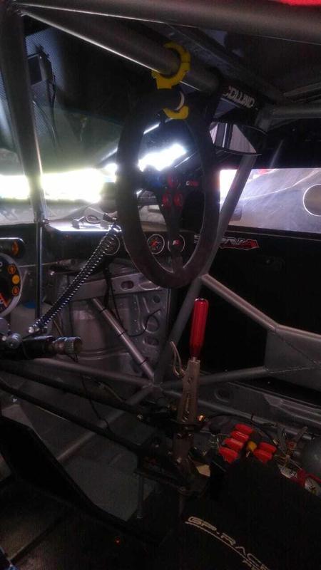 Support for car steering wheel in roll cage