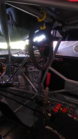 Support for car steering wheel in roll cage