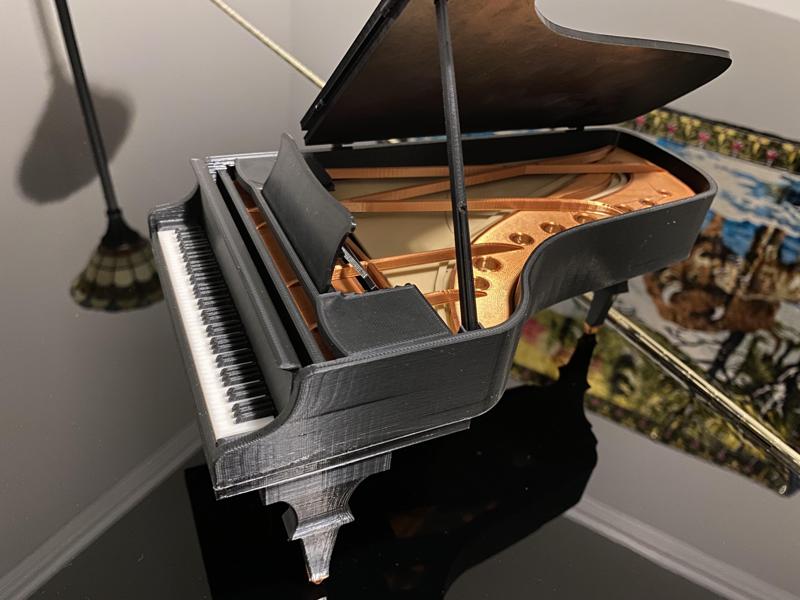 Grand piano with moving parts