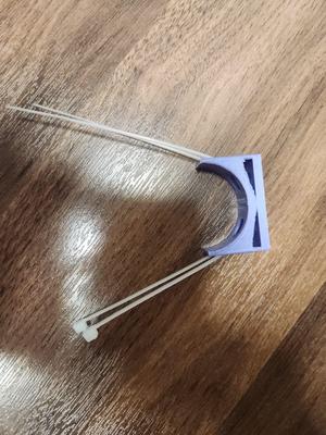 Wall pipe holder with zip tie