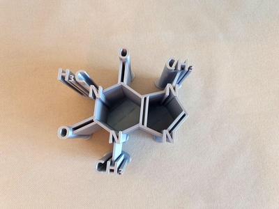 Pen holder shaped like a caffeine molecule 