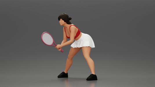 sexy tennis player in skirt holding her racket in a ready position