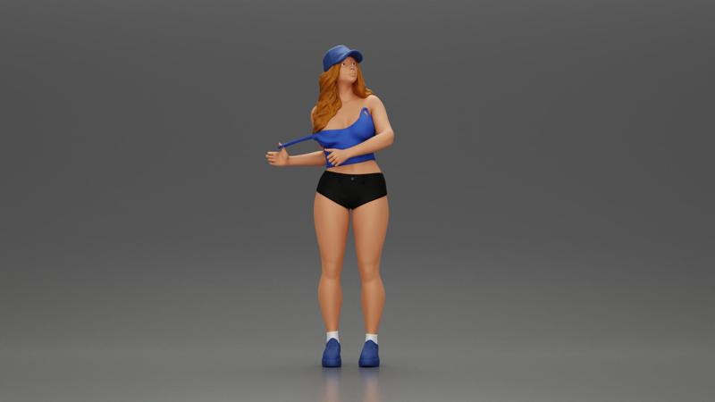 sexy girl standing in shorts and cap pulling off her bra