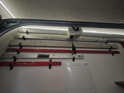 Puzzle holder for spirit level and straight edge