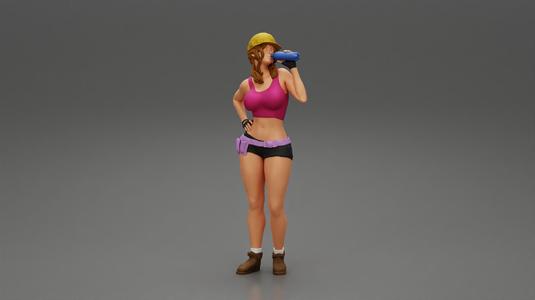 Sexy girl mechanic drinks water during a break