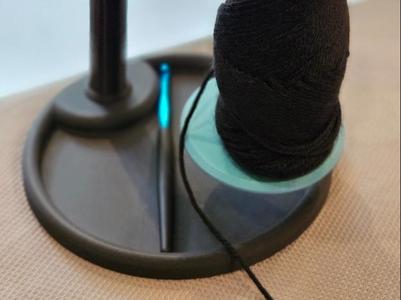 Rotating flat pack variable height yarn holder