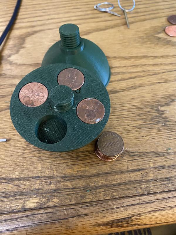 Bottom half holds pennies to add weight
