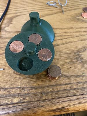 Bottom half holds pennies to add weight