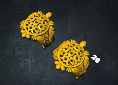 tortois pair of earrings with ornate design