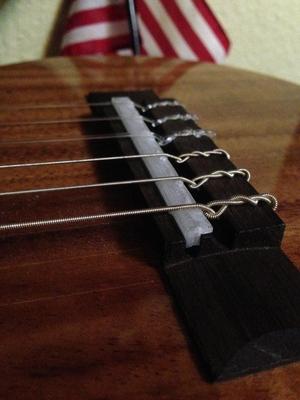 Guitar bridge to fix sharp intonation