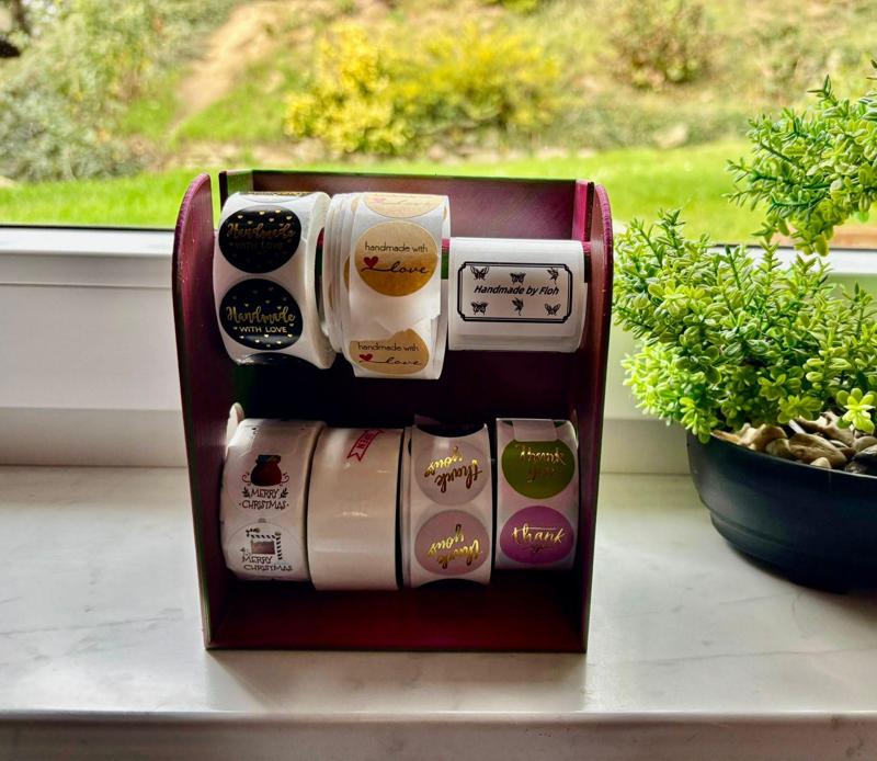 Label dispenser, sticker roll holder, sticker roll holder