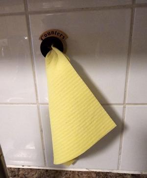 Dish towel push holder
