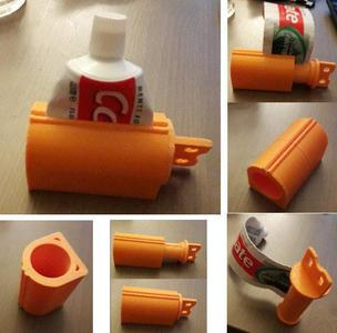 Toothpaste tube pusher with wide wheel adapted for handicapped grip
