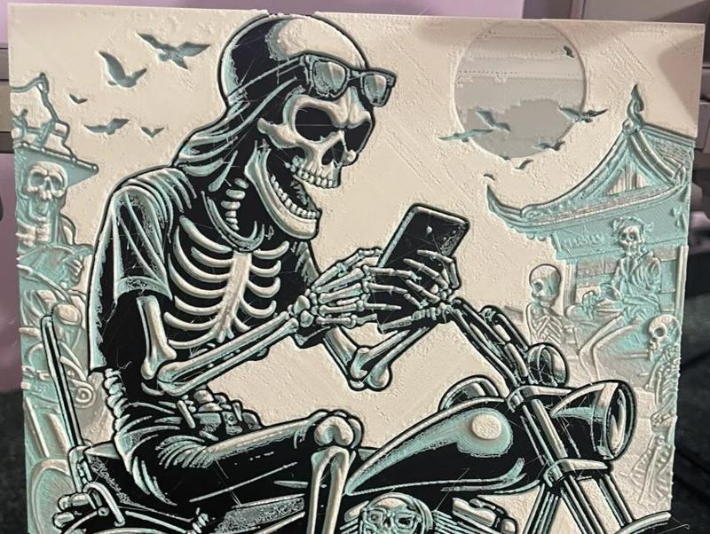 A Skeleton with Mobile on Motorcycle