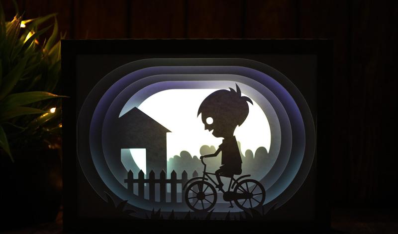 boy riding bicycle lightbox