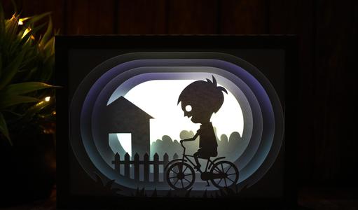 boy riding bicycle lightbox