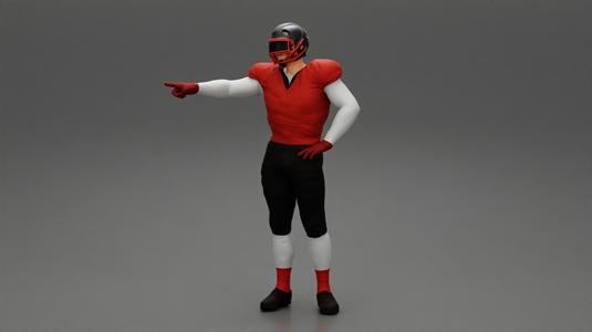 Rugby player standing pointing to the ball