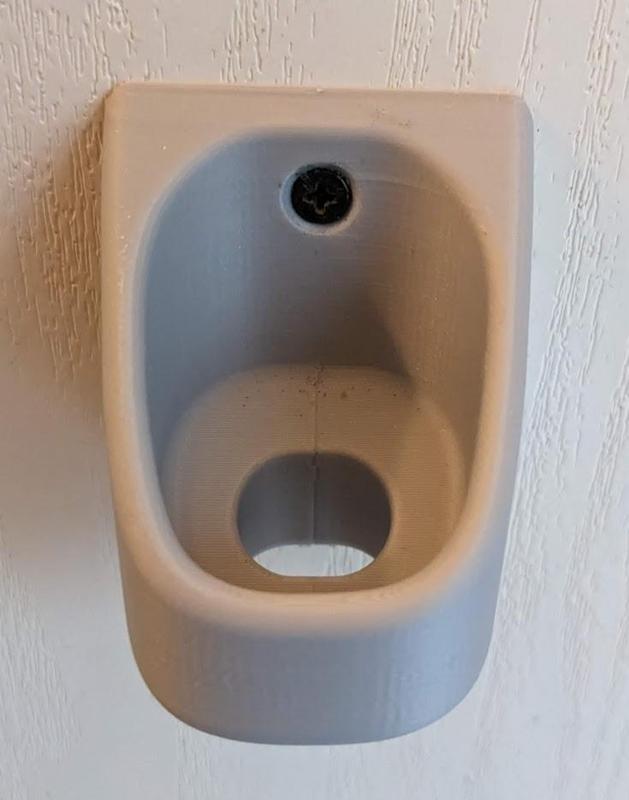 OneBlade Pro wall mount with hole for charging cable