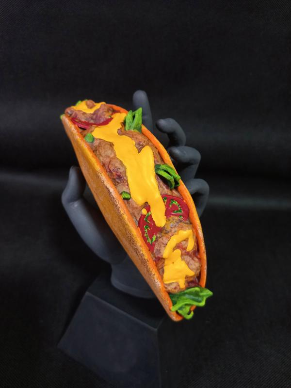 Hand holding a Mexican Taco