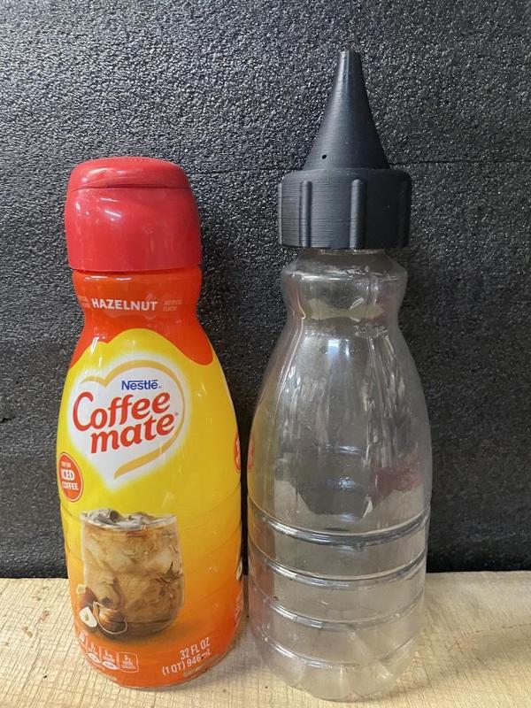 Coffee creamer to plant watering container.