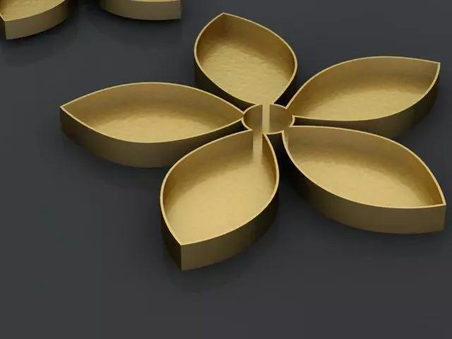 cutterd three golden flower shaped plates