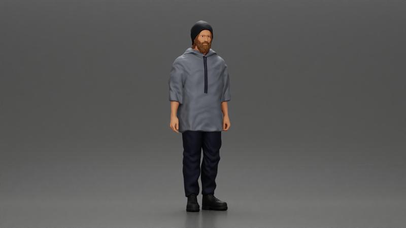 man wearing a hat and hoodie stands confidently watching intently