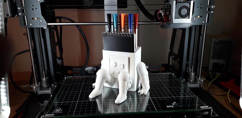 Pen and pad holder robot.