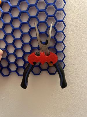 Batman plier holder for honeycomb wall