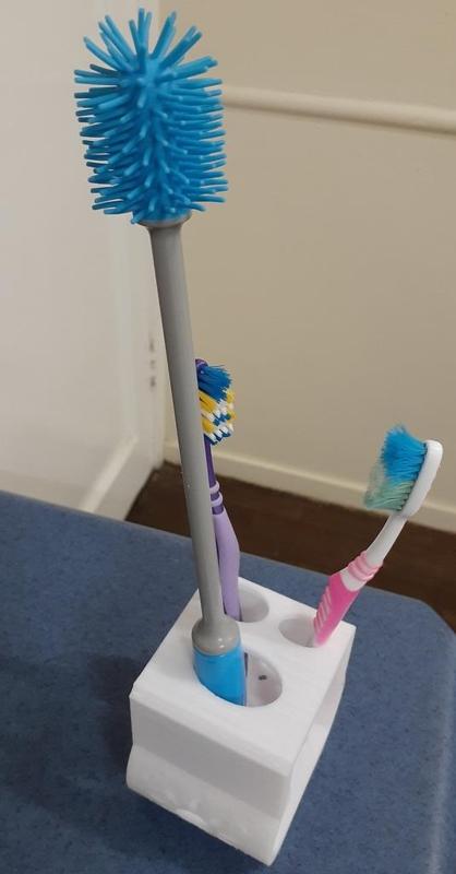 Cleaning Brushes Holder      The Larger Brush is actually for cleaning drinking Glasses, Bottles and Flower Vases or similar Household objects,  (The toothbrushes are used no longer for cleaning teeth but are for cleaning household/kitchen glassware items