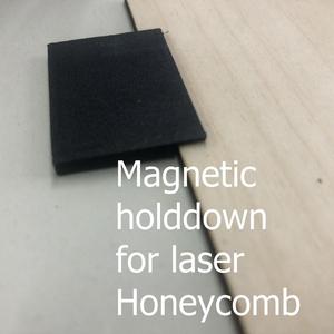 Magnetic holddown for honeycomb bed on laser engraver
