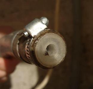 Washing machine outlet flow reducer