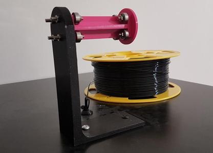 Fixed spool holder for closed enclosure with opening lid
