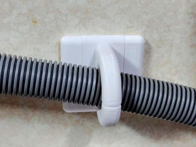 Dishwasher drain hose wall hook