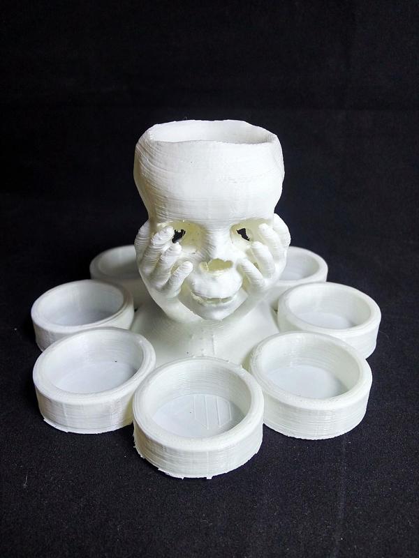 Skull in hand candle holder