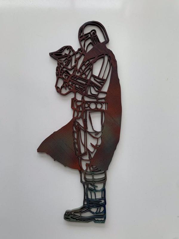 The Mandalorian holding Grogu