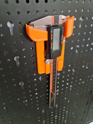 Caliper holder for perforated wall