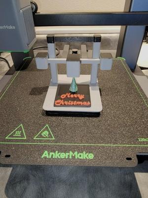 Model of an AnkerMake M5C printing a holiday design