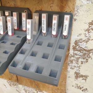 Wall mounted bracket for small tooling in packaging (square cross-section)